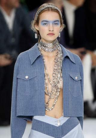 A model presents a creation by German designer Karl Lagerfeld as part of his Spring/Summer 2016 women’s ready-to-wear collection for French fashion house Chanel at the Grand Palais during the Fashion Week in Paris
