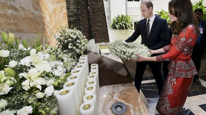 Britain’s Prince William and his wife Catherine, Duchess of Cambridge, hold a wreath as they pay their respects at the 26/11 memorial at the Taj Mahal Palace hotel, one of the sites of the 2008 attacks, in Mumbai, India