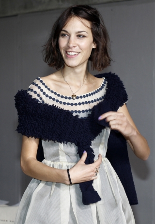 MTV presenter Chung waits for the start of the Christopher Kane Fall/Winter 2011 collection show at London Fashion Week