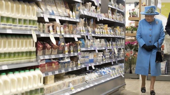 Britain’s Queen Elizabeth looks at products on the shelves at a Waitrose supermarket during a visit  to the town of Poundbury