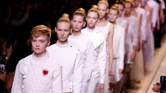 Models present creations by Italian designer Maria Grazia Chiuri as part of her Spring/Summer 2017 women’s ready-to-wear collection for fashion house Dior during Fashion Week in Paris