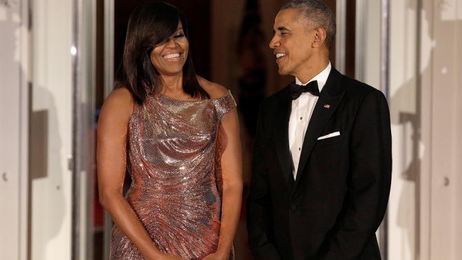 U.S. President Barack Obama and U.S. first lady Michelle Obama speak before the arrival of Italian Prime Minister Matteo Renzi and his wife Agnese Landini at the White House in Washington.