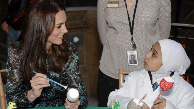 Britain’s Catherine, Duchess of Cambridge makes a dinosaur egg whilst attending a children’s tea party with pupils from Oakington Manor Primary School in Wembley, at the Natural History Museum in London
