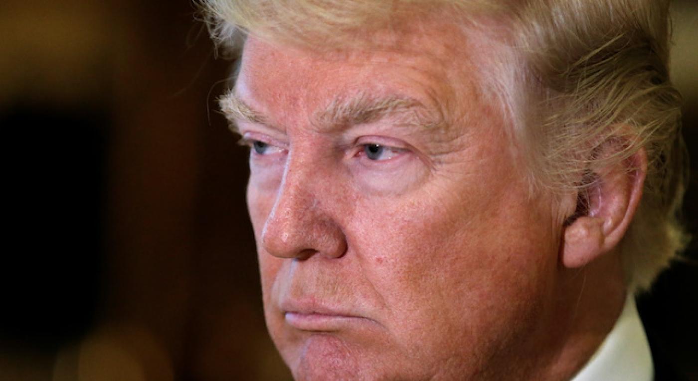 U.S. President-elect Donald Trump listens to questions from reporters in the lobby at Trump Tower in New York