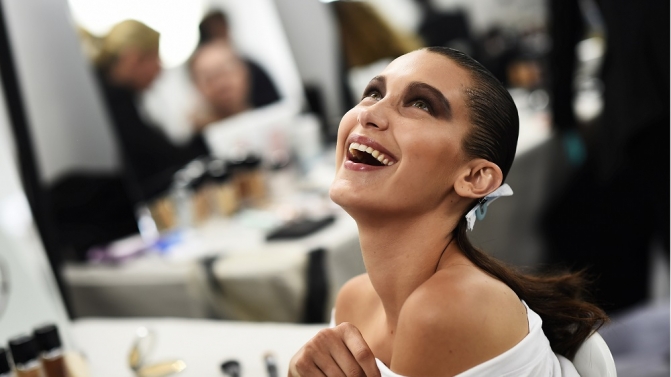 Model Bella Hadid smiles as she has her make-up applied inside Blenheim Palace ahead of a Dior fashion show in Woodstock