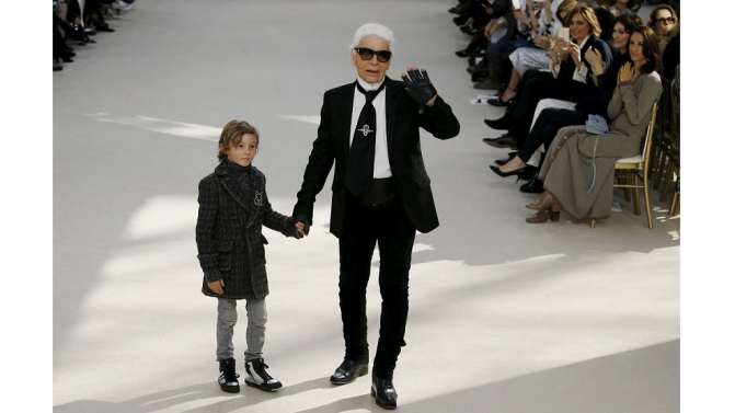 German designer Karl Lagerfeld and model Hudson Kroenig appear at the end of his Fall/Winter 2016/2017 women’s ready-to-wear collection for fashion house Chanel at the Grand Palais in Paris