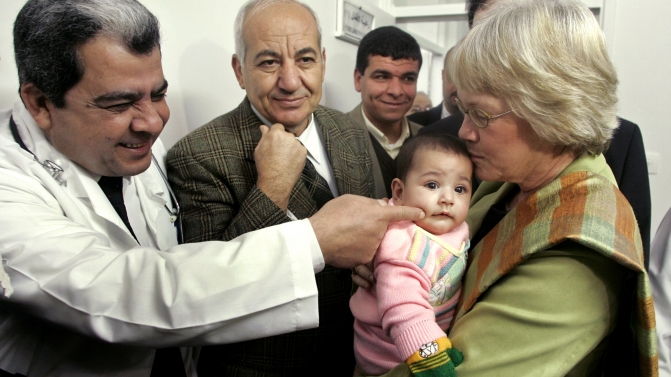 UNRWA general commissioner Karen Abuzayd holds a baby during her visit to Shati hospital in Shati refugee camp in Gaza