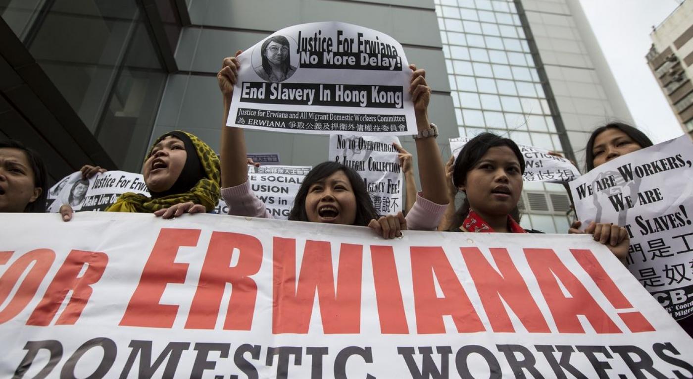 A supporter holds a sign with a drawing of Indonesian domestic helper Erwiana Sulistyaningsih, during a protest calling for better protection of migrant workers, outside the Kwun Tong Magistrates’ Court in Hong Kong
