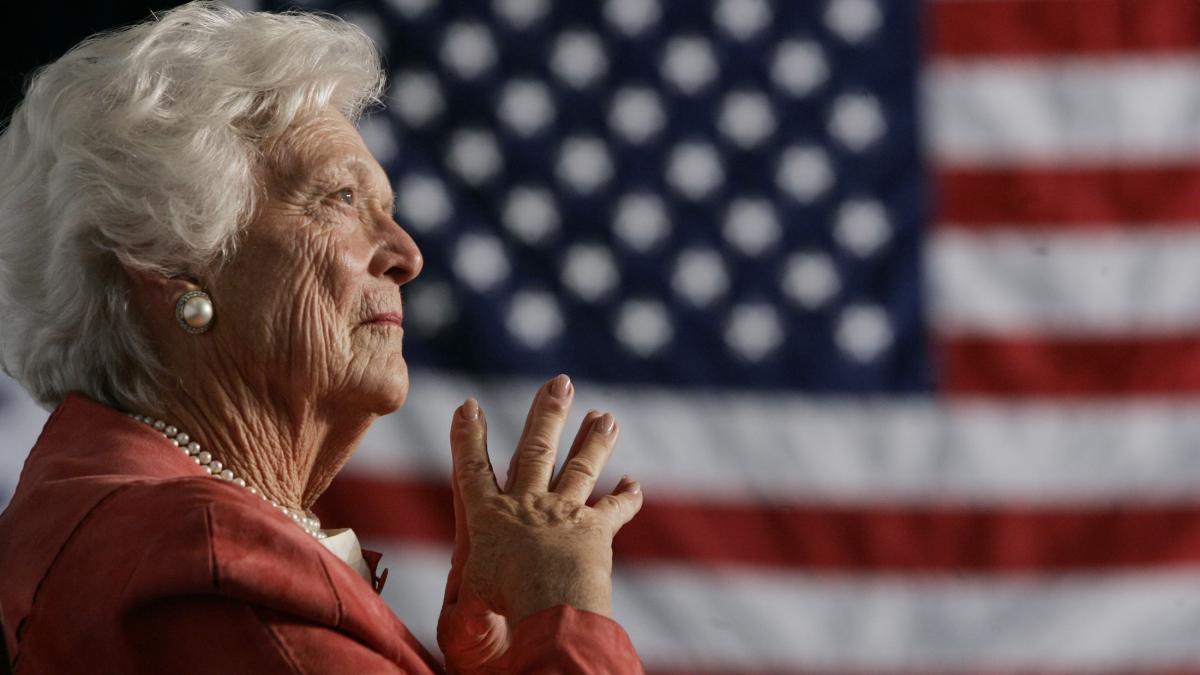Former U.S. first lady Barbara Bush listens to her son President George W. Bush at an event in Orlando.