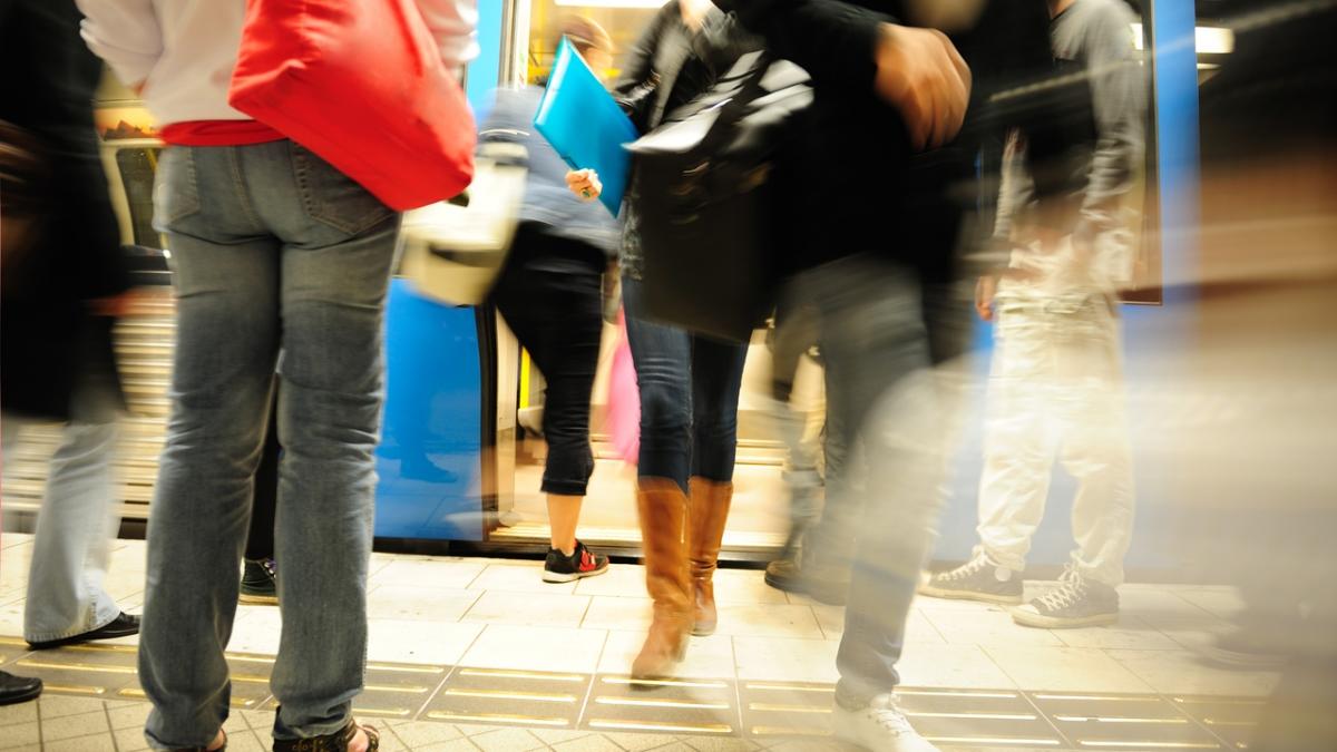 Commuters entering and exiting subway train