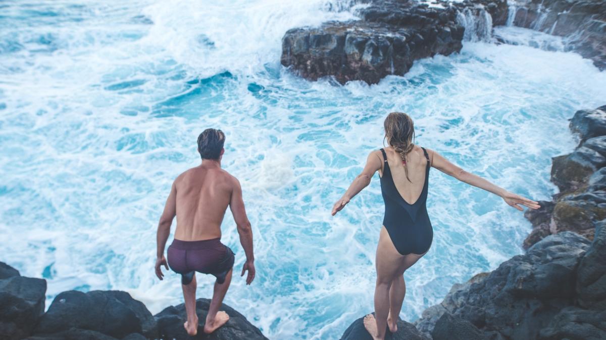 A millennial-age couple getting ready to jump into the ocean