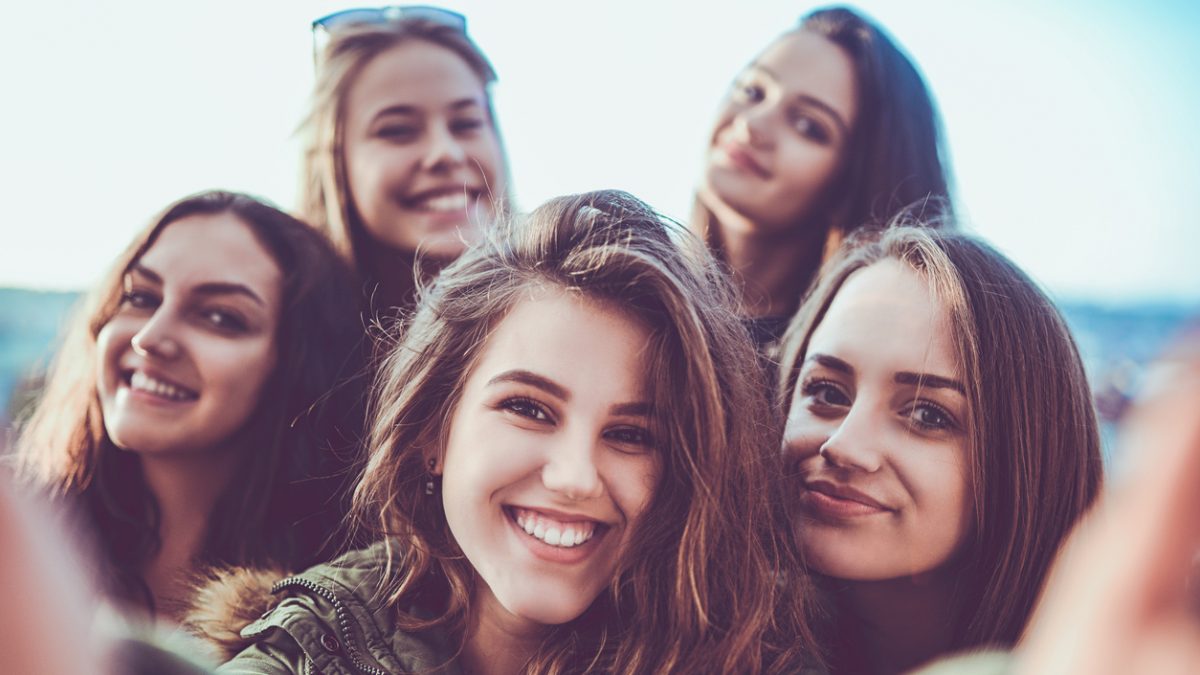 Group of Crazy Girls Taking Selfie and Making Faces Outdoors