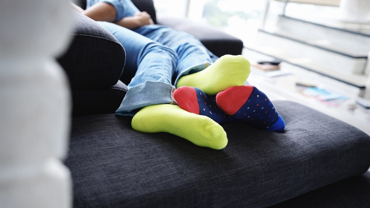 Young Man and Woman Kissing Holding Hands on Sofa