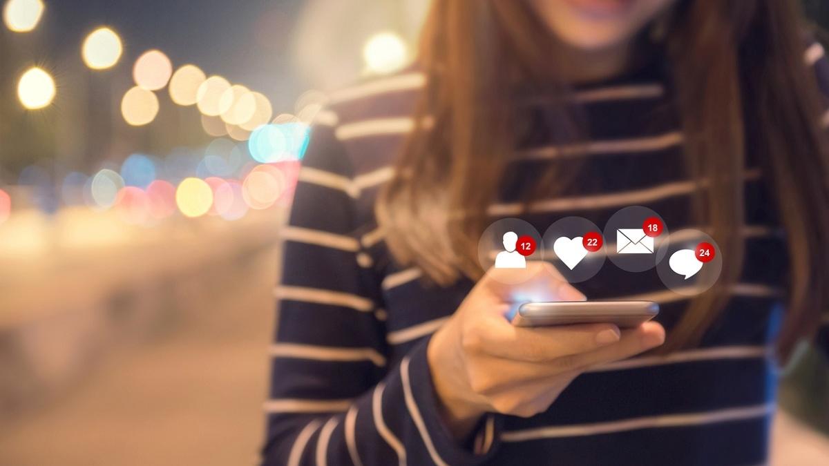 Happy woman hands using mobile smartphone with icon social media and social network.