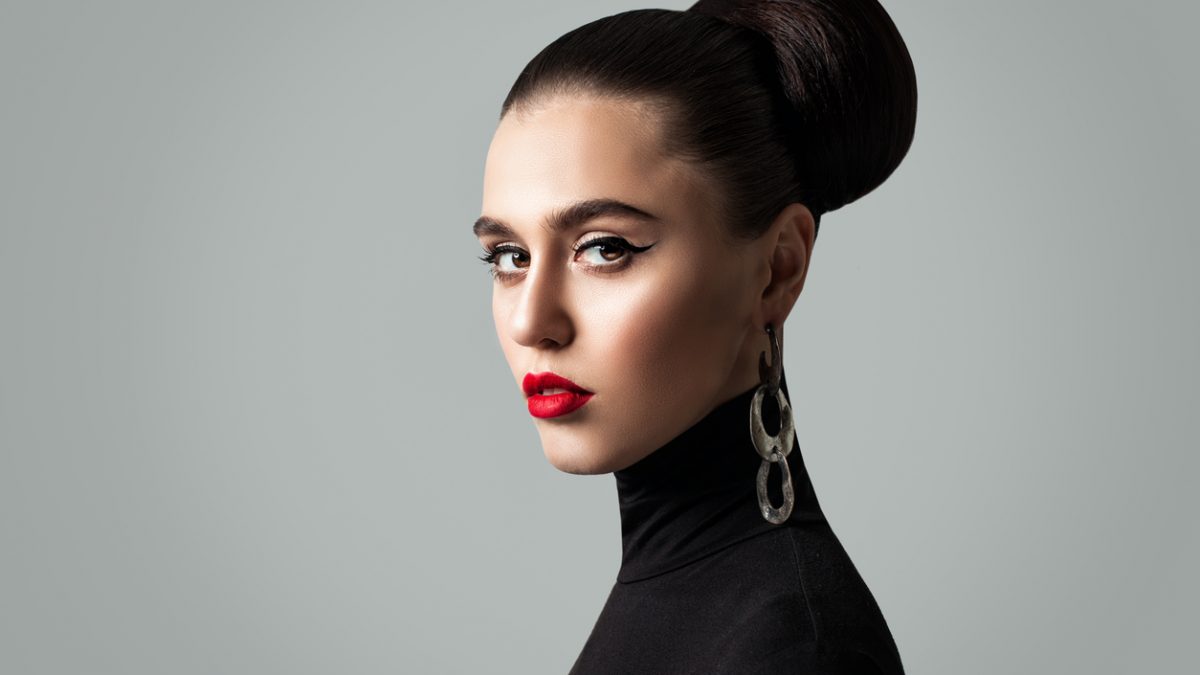 Gorgeous Woman with Perfect Hairstyle and Eyeliner Makeup. Cute Female Model Face