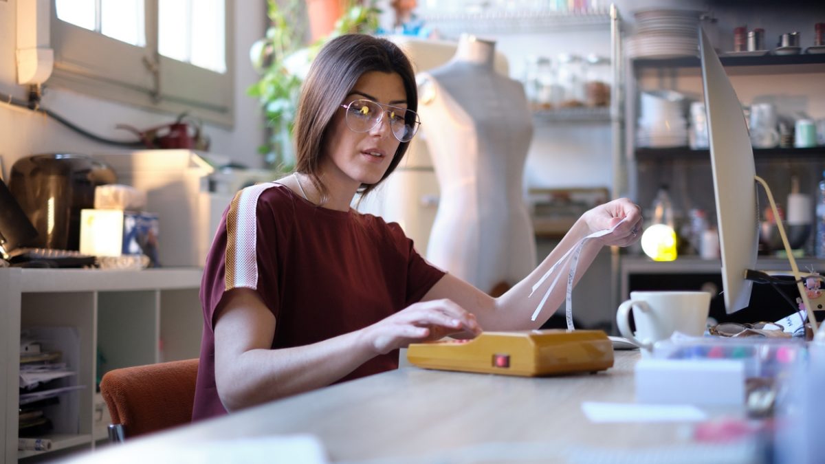Pregnant designer working in her workshop. Pregnant designer working in her workshop.