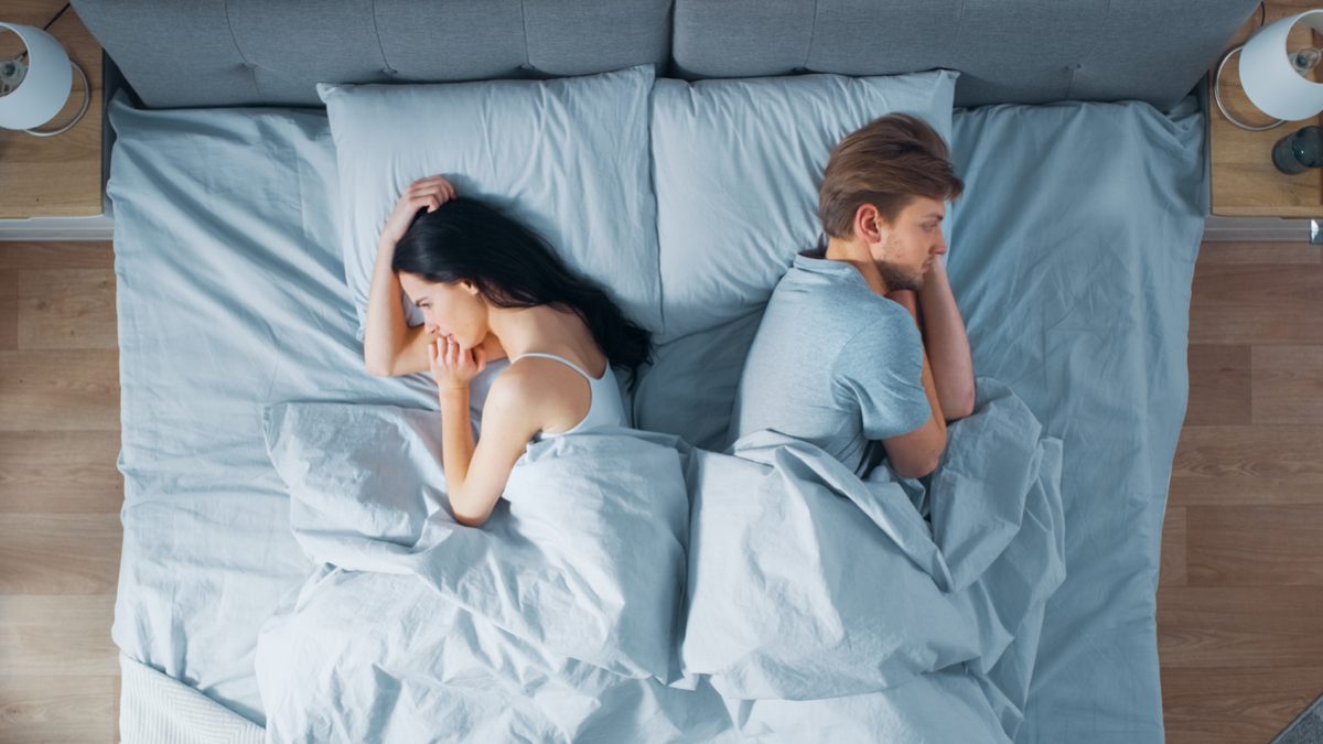 Quarrelling Young Couple in the Bed, Young People Lying Turned Away From Each other and Lay on Their Sides Holding Grudges and Being Offended