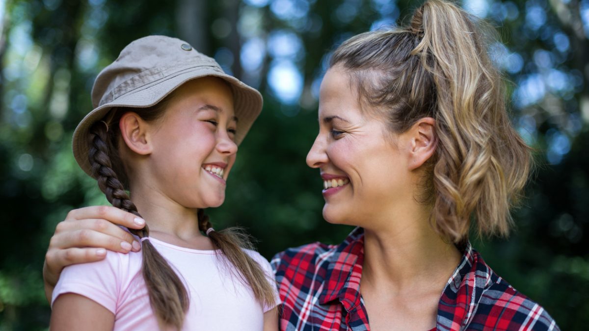 Cheerful mother looking at daughter
