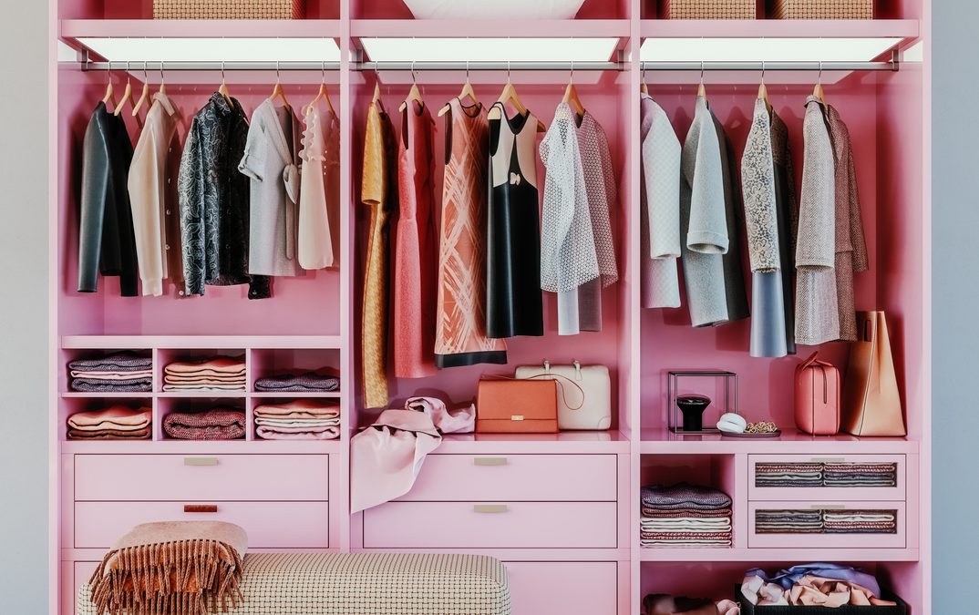 modern pink wardrobe with clothes hanging on rail in walk in closet design interior, 3d rendering
