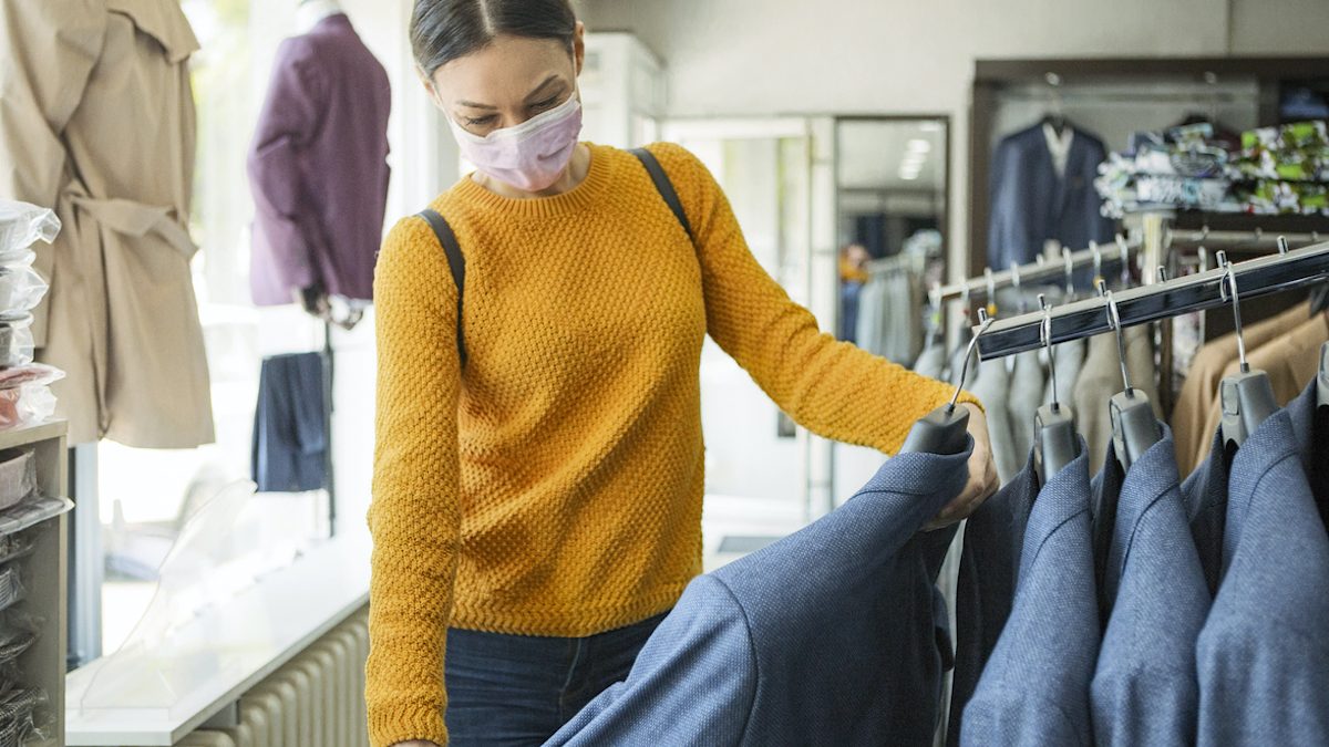Young woman shopping at the time of virus wearing protective mask
