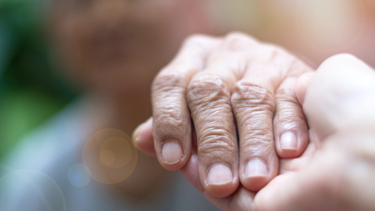 Caregiver, carer hand holding elder hand woman in hospice care. Philanthropy kindness to disabled concept.Public Service Recognition Week