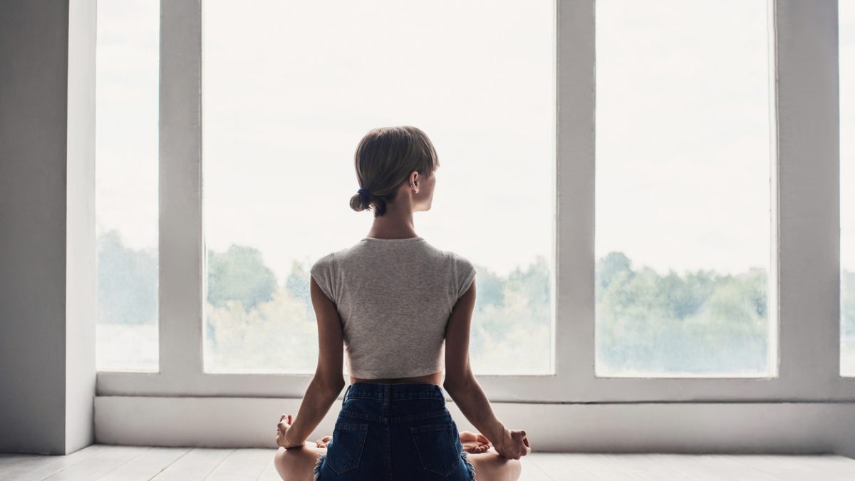Young woman practicing yoga at home
