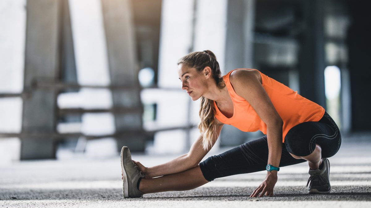 Female Athlete Stretching Outdoors