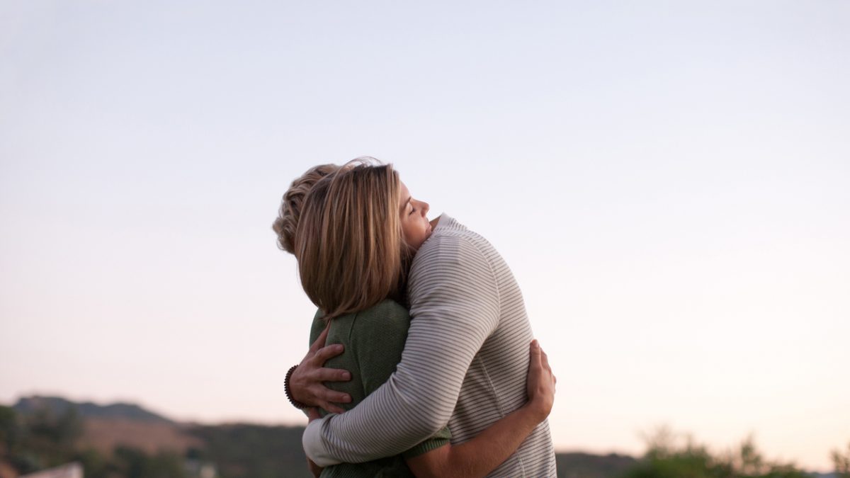 Couple hugging outdoors
