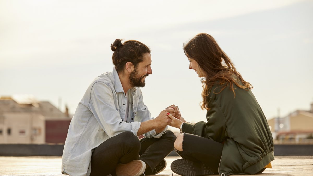 Young couple holding hands at rooftop